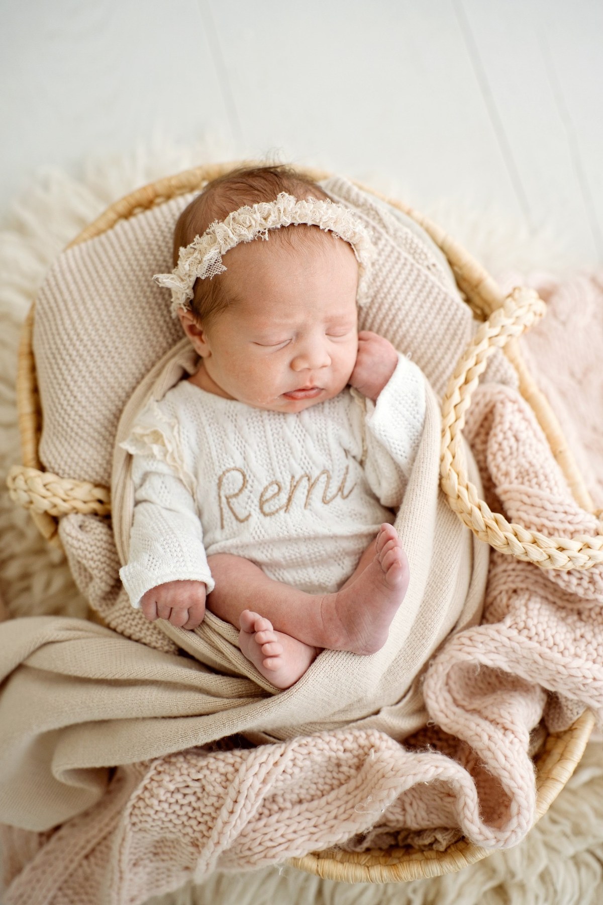 Newborn wearing a handmade personalised romper by Sweet Sews by Ann