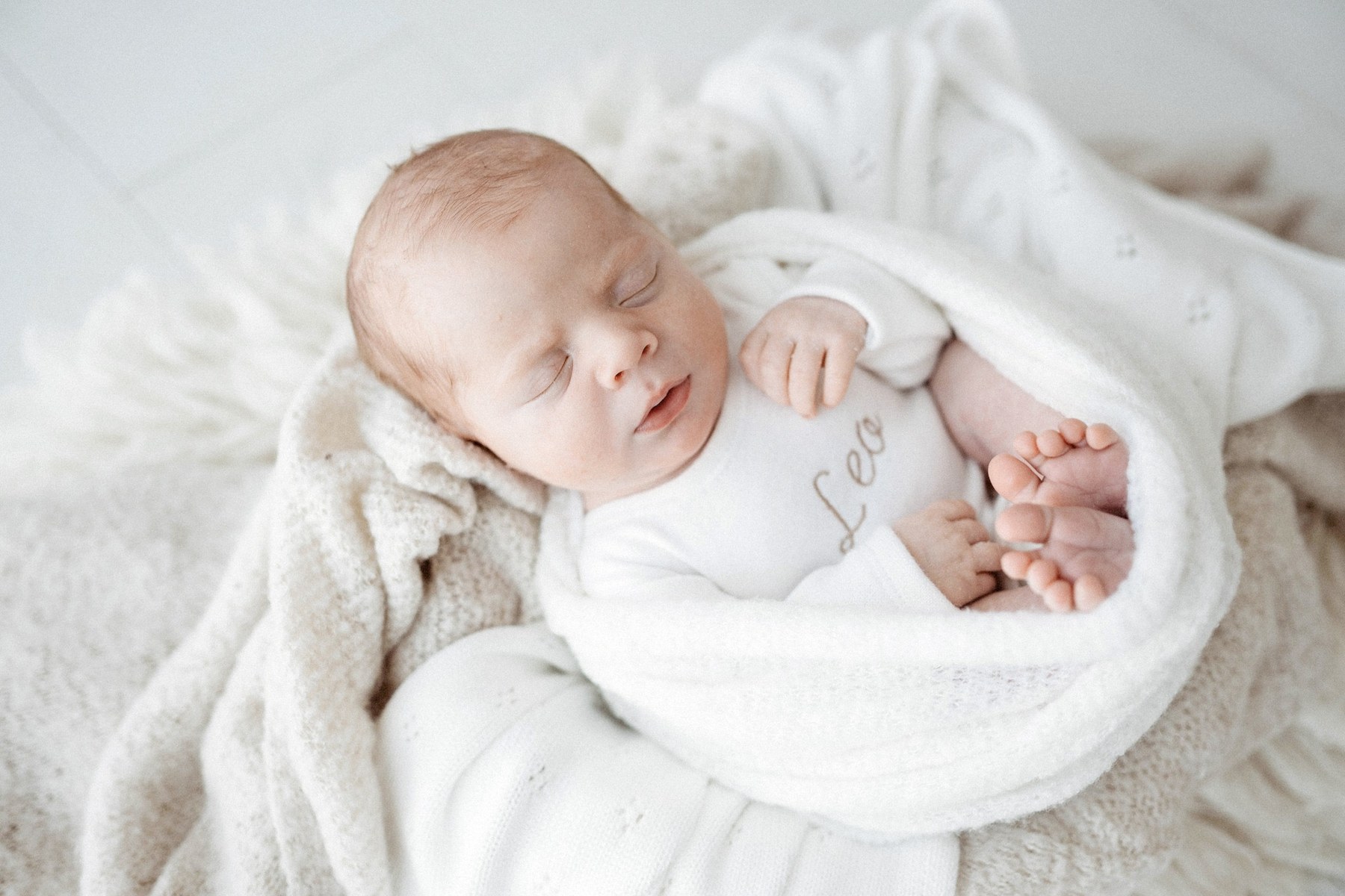 Newborn wearing a handmade personalised romper by Sweet Sews by Ann