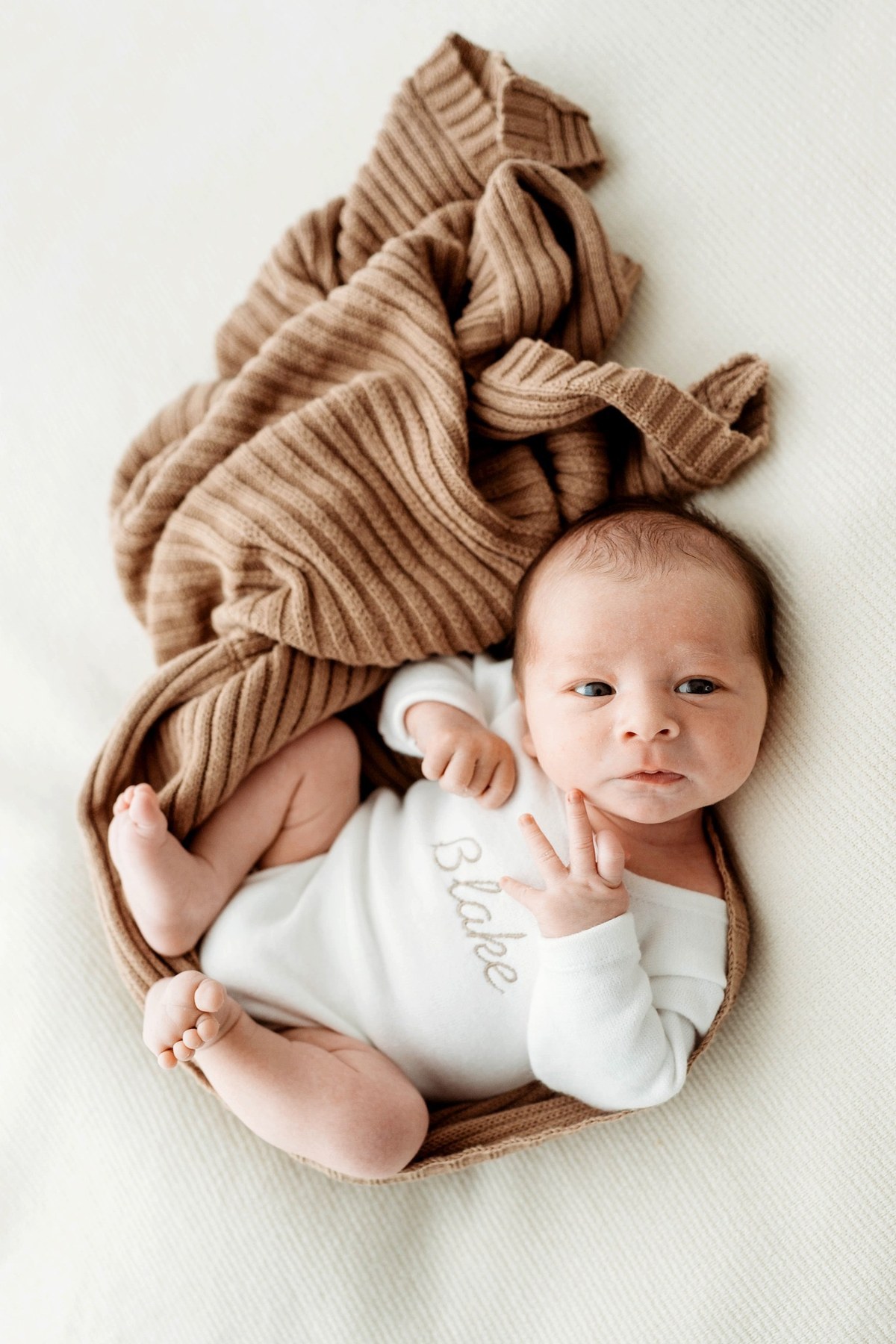 Newborn wearing a handmade personalised romper by Sweet Sews by Ann